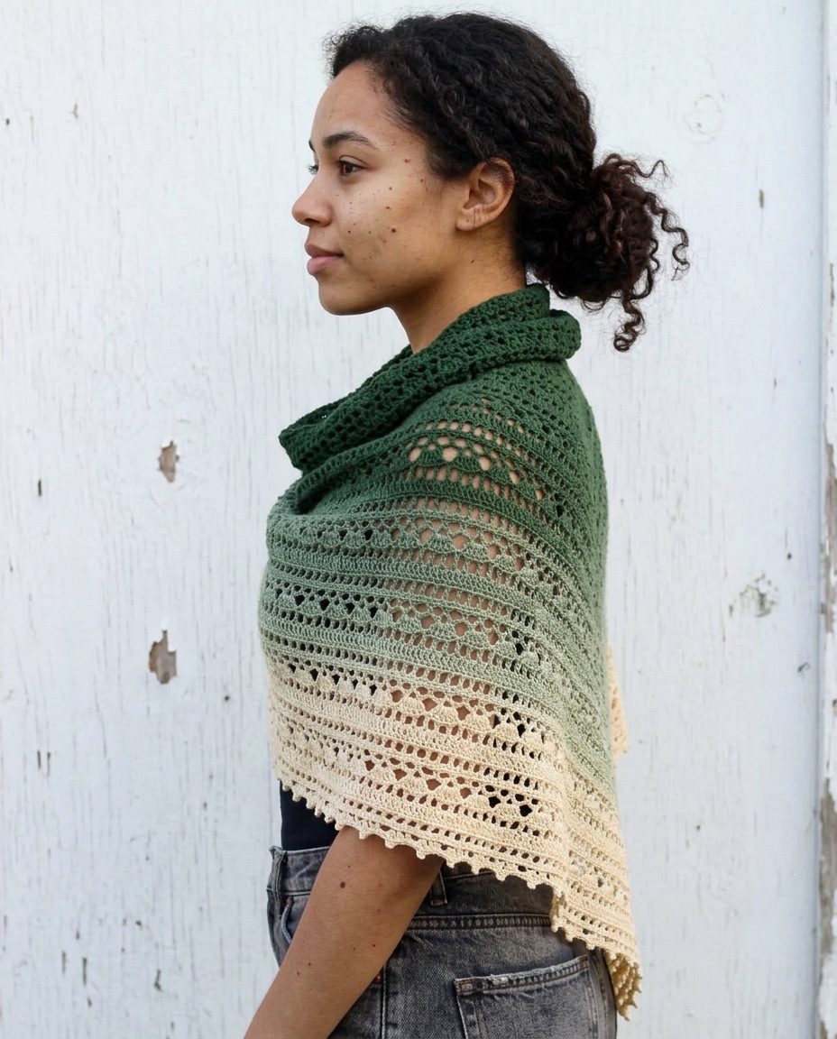 Green to cream gradient crochet shawl with rows of cluster stitches and a scalloped lace edge, wrapped around the shoulders