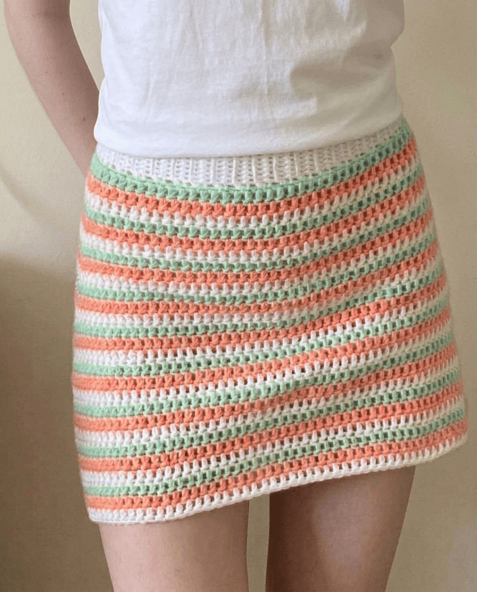 Crochet mini skirt with thin horizontal stripes in cream coral and mint green cotton