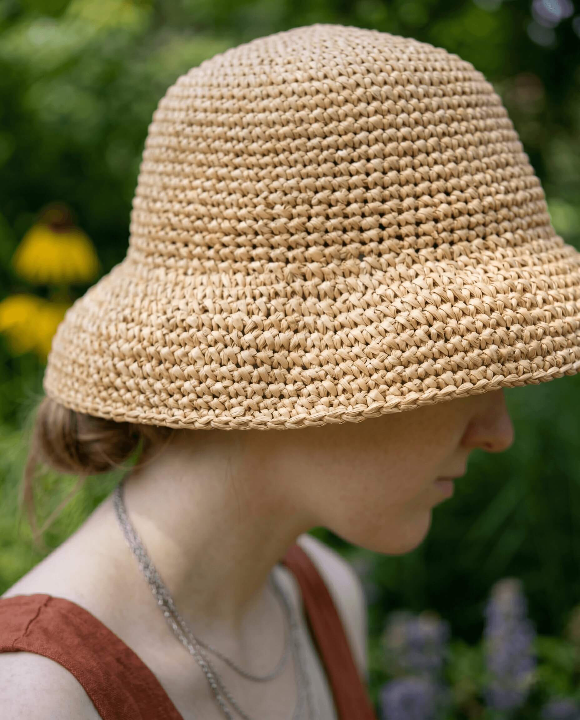 Millie Belle crochet sun hat with a wide raffia brim in a natural straw color