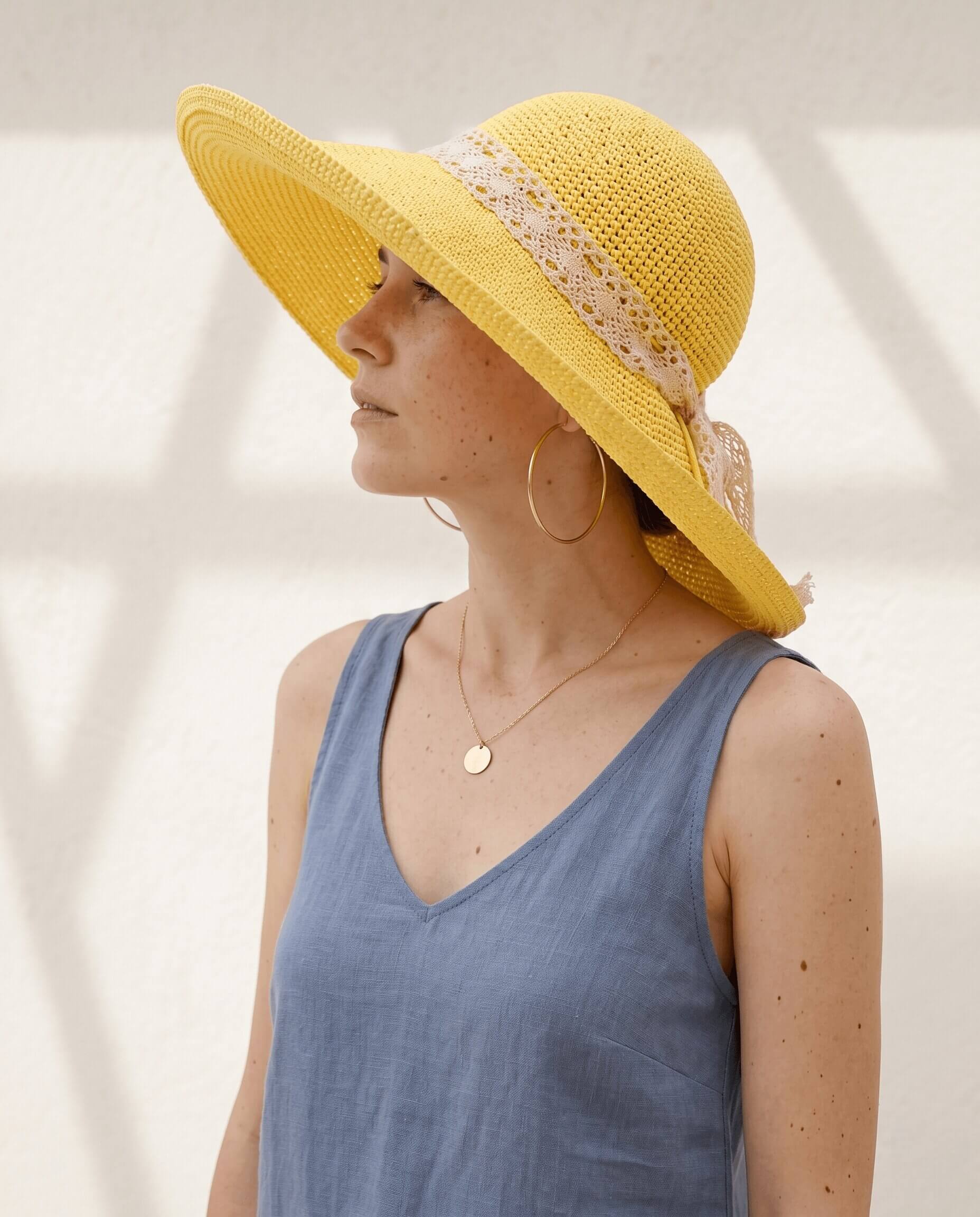 Wide brim crochet sun hat worked in raffia yarn with an adjustable leather cord