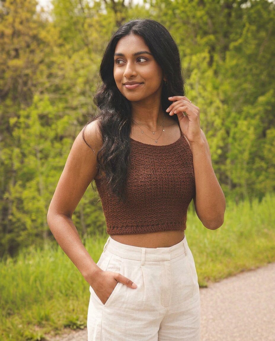 Cropped crochet tank top in warm chocolate brown with a scoop neckline, thin straps, and a simple textured stitch