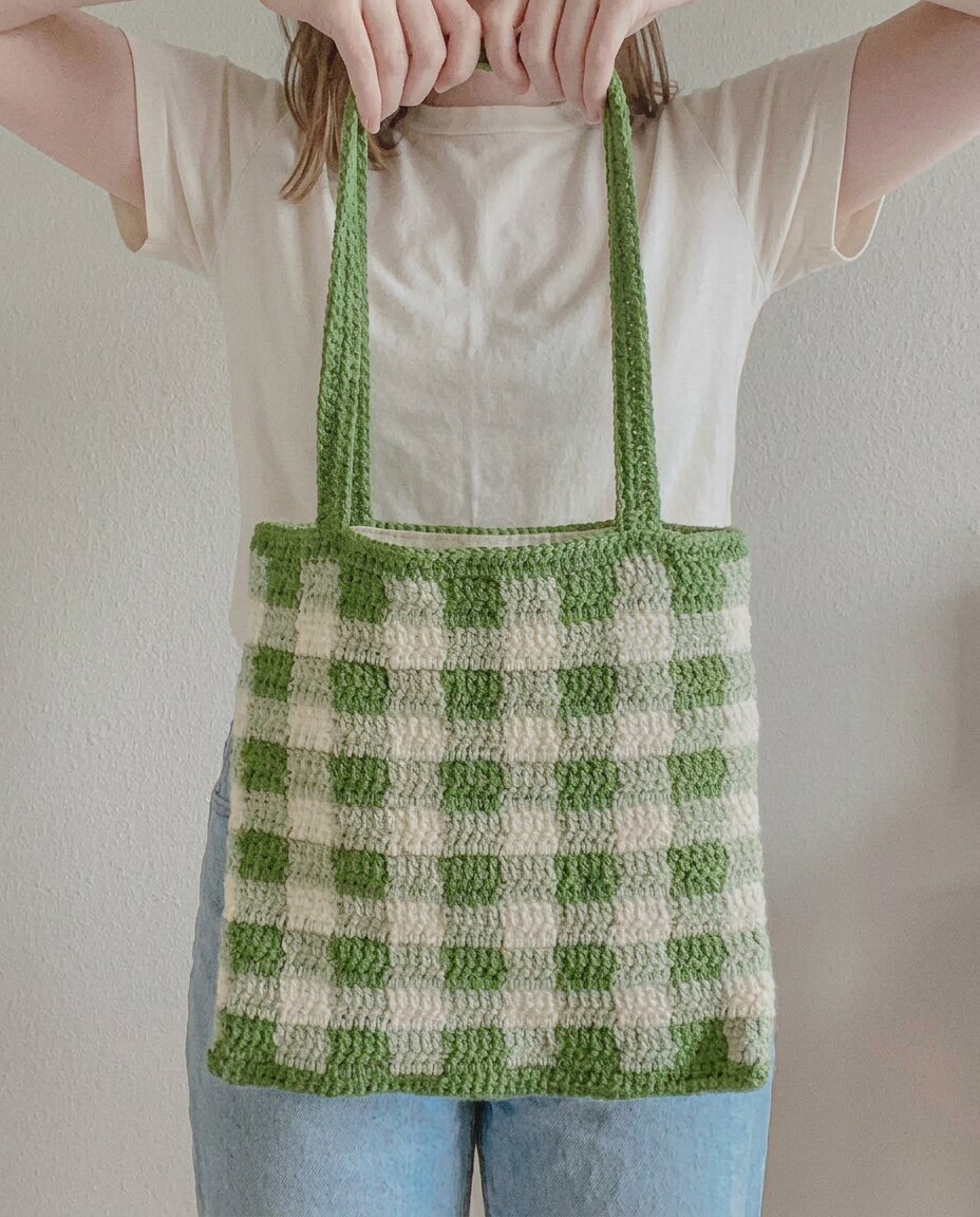 Crochet tote bag in a green and cream gingham check pattern with long flat shoulder straps
